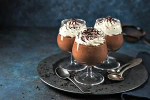 chocolate mousse served with whipped cream, selective focus,