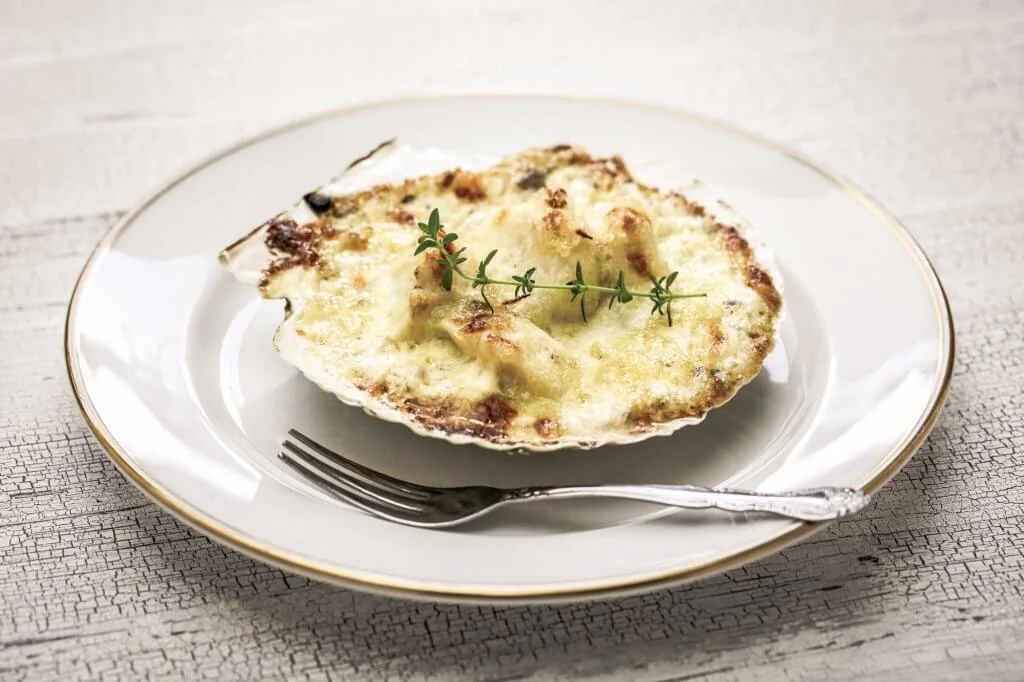 coquilles saint jacques on a white plate