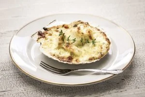 coquilles saint jacques on a white plate