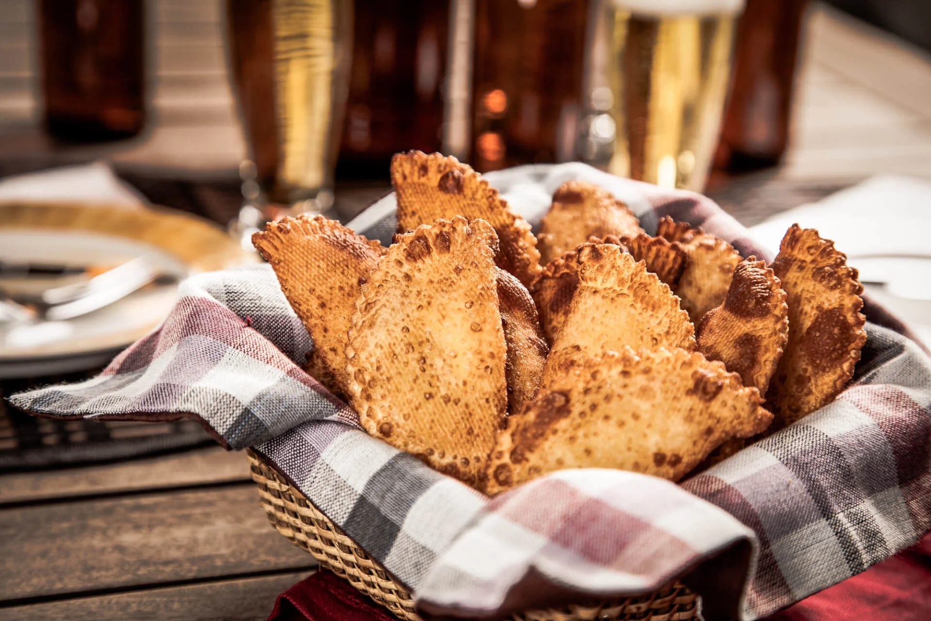 Pastel, a Brazilian snack, with a bar in the background.