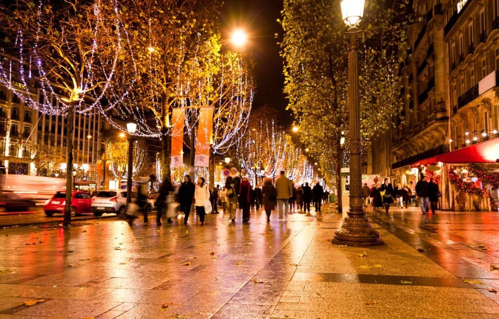 the famous shopping district Champs Elysees illuminated with Christmas lights in Paris in winter