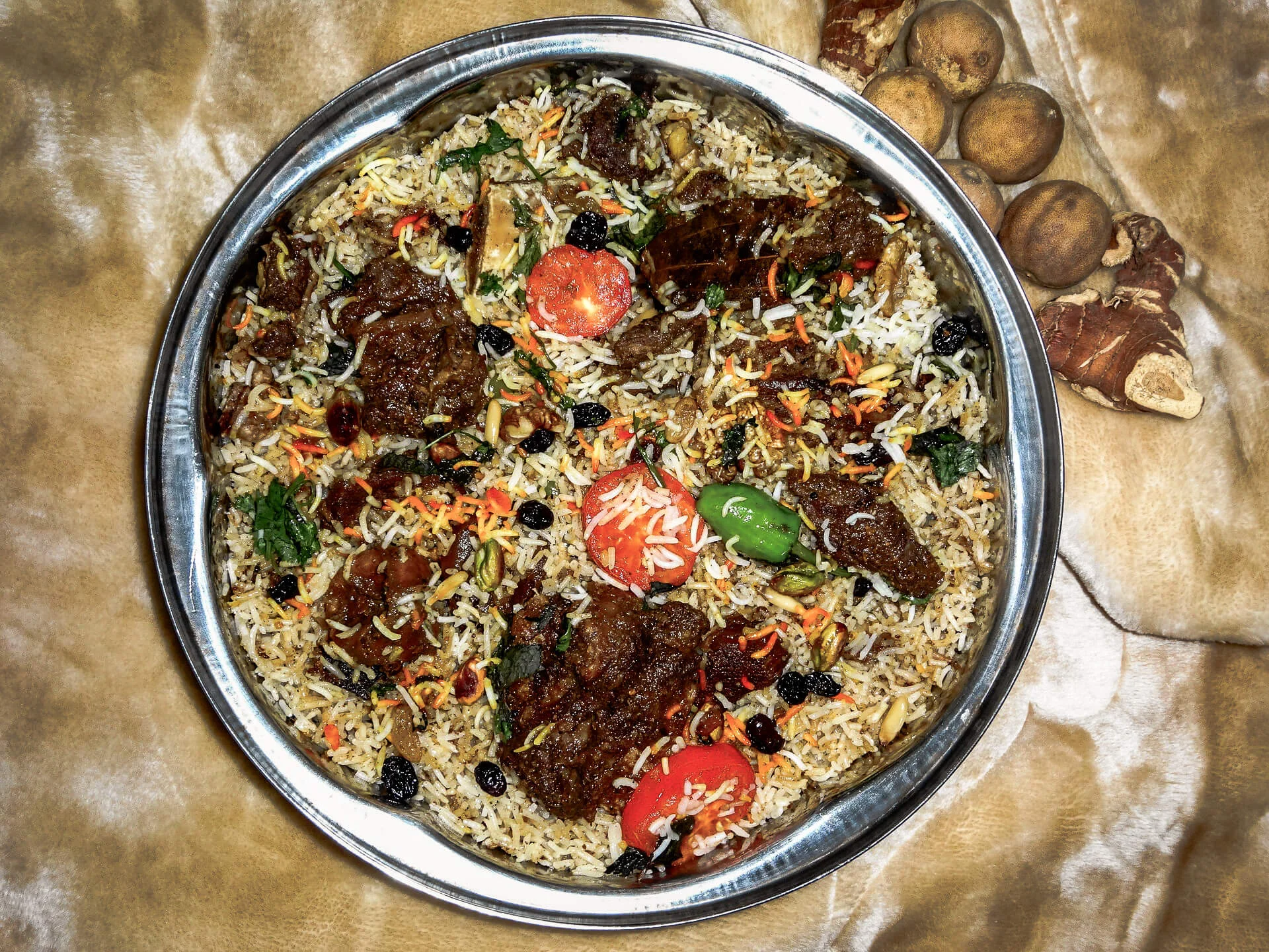 overhead photo of camel meat biryani in a dish