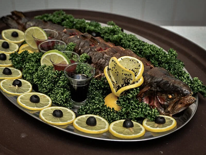 fish levengi on a platter with lemon slices