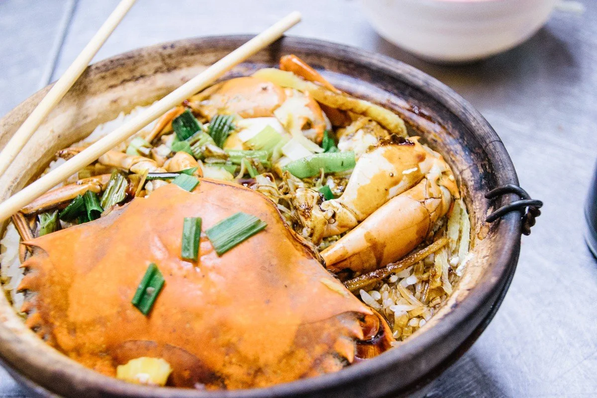 rice and seafood in a bowl with chopsticks